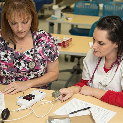 medical student taking blood pressure