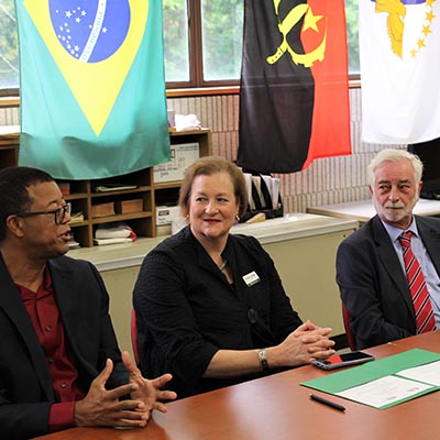 Multicultural meeting with nation flags in background