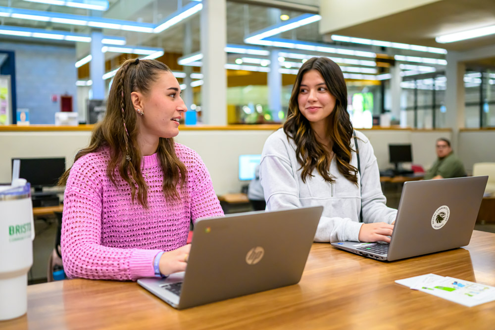Two Bristol students sitting together in the library