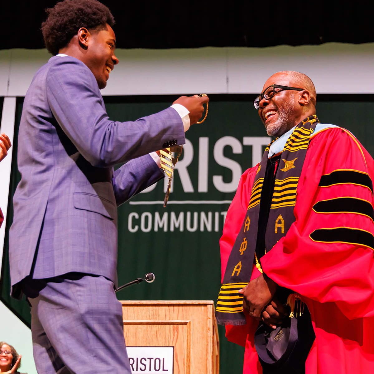 President Harris receiving the medallion from his son at the inauguration ceremony