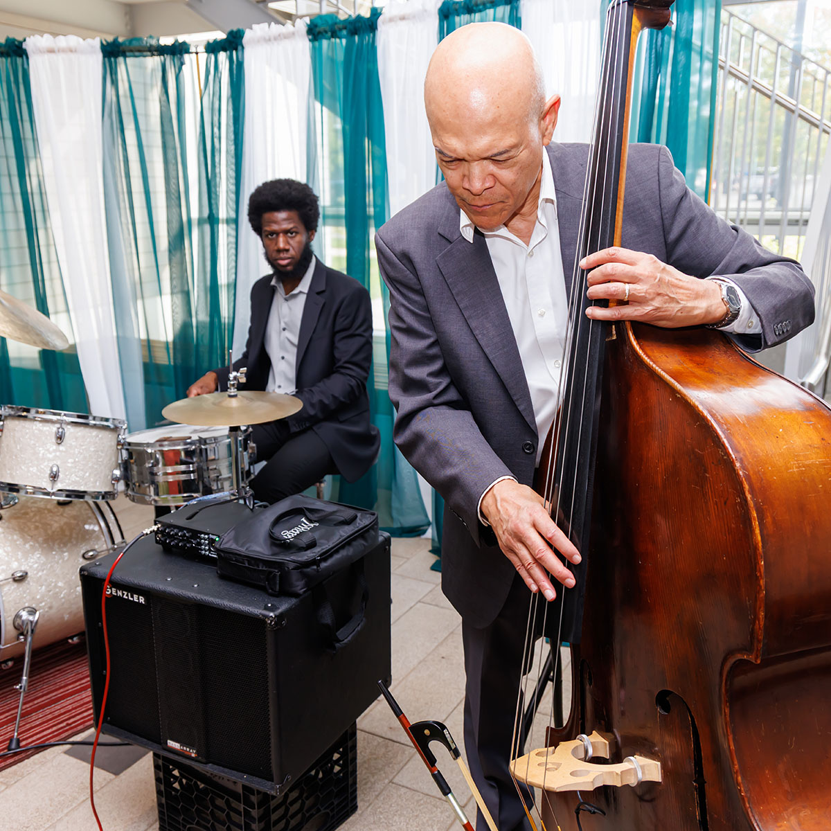 A jazz bassist and drummer playing at the inauguration ceremony reception