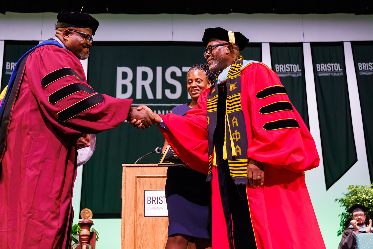 Dr. Harris on stage shaking hands at Inauguration