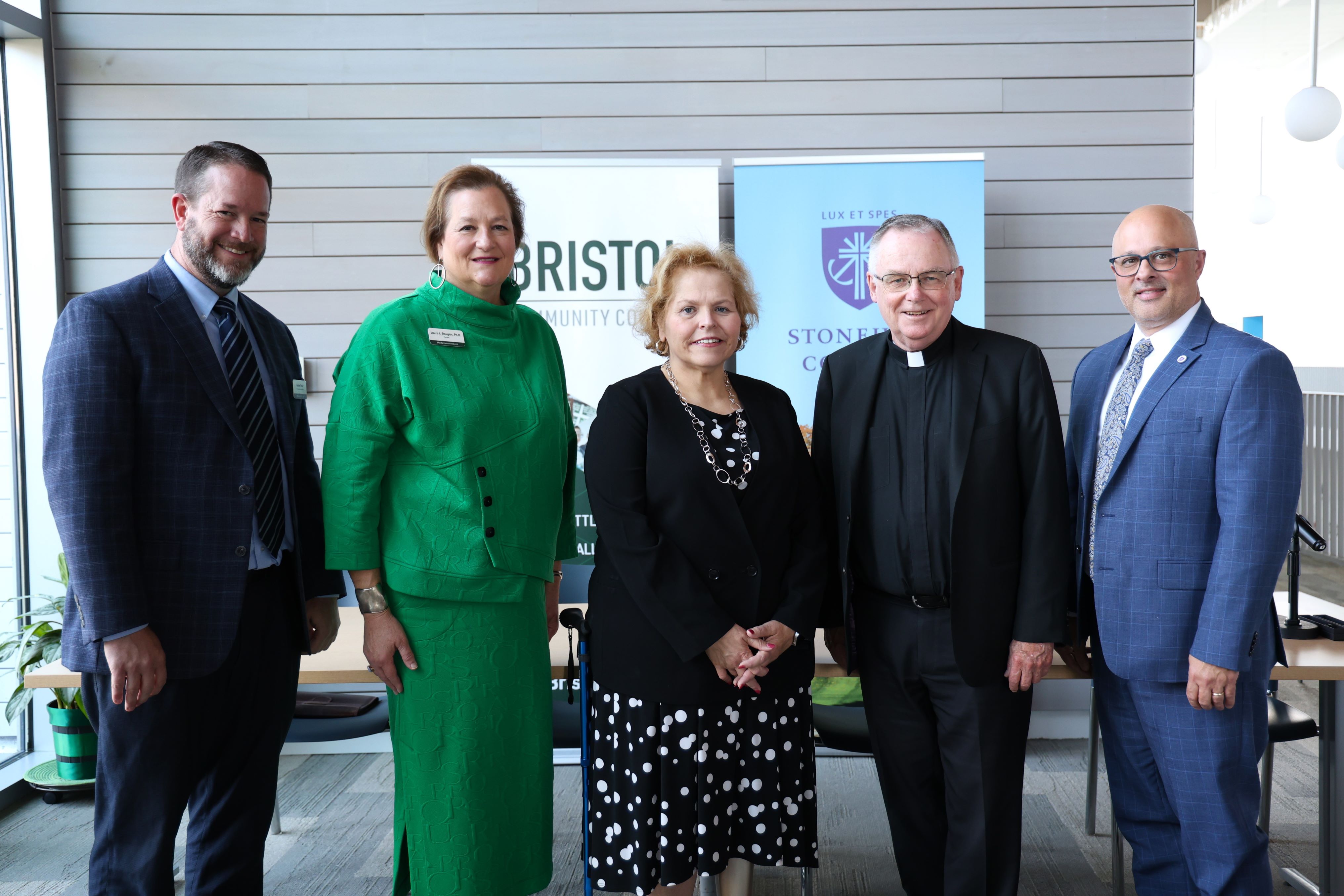 Left to Right: Vice President of Academic Affairs Andrew Fisher (Bristol), President Laura L. Douglas (Bristol), Board Chair Joan M. Medeiros (Bristol), President John Denning, C.S.C. (Stonehill), Vice President for Academic Affairs Peter Ubertaccio (Stonehill)