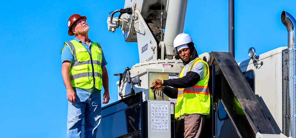 Crane instructor and student operating machinery