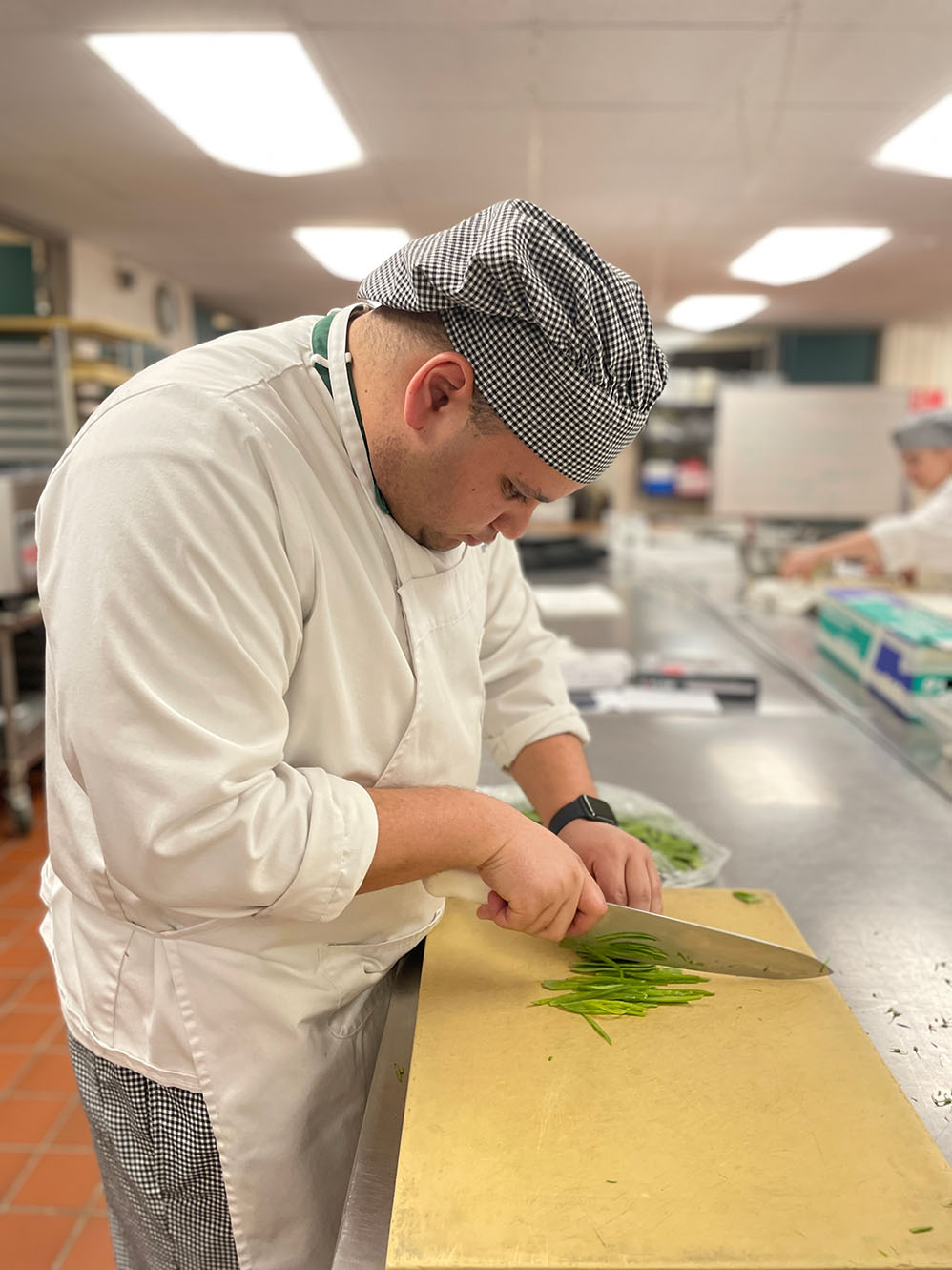 Bristol culinary arts student piping onto small pastries