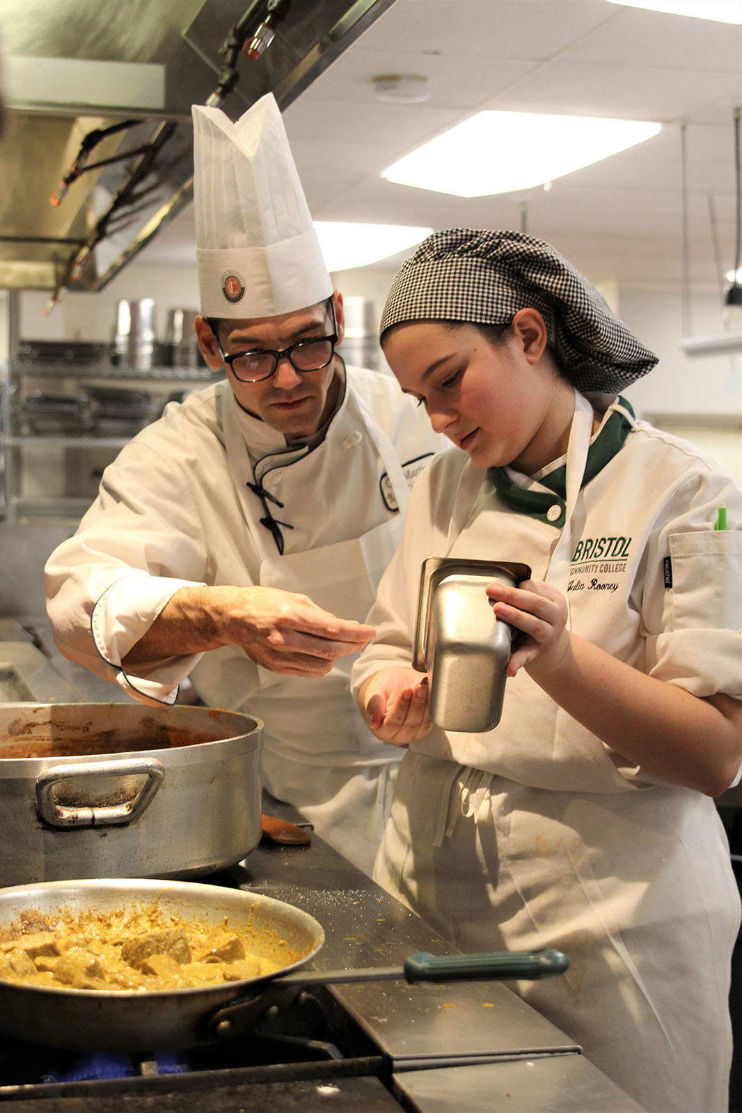 Culinary professor Esteban Martinez teaching a student