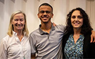 three individuals smiling for camera