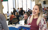 two people interacting on campus and having lively conversation