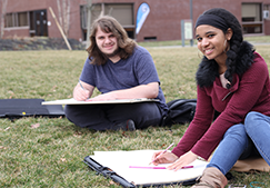 Students sitting on grass - Get Started