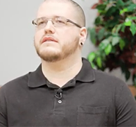 person wearing glasses and black collared shirt