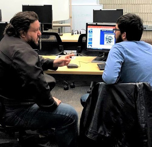 MAICEI student and teacher in computer lab