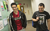 students walking down the hallway wearing backpacks