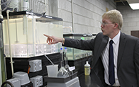 person pointing at industrial lab equipment