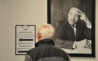 person viewing wayfinding sign on wall