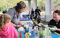 adult and child interacting at event