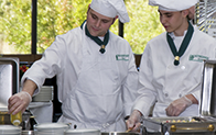 two culinary students prepping a dish