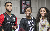 three students smiling at camera