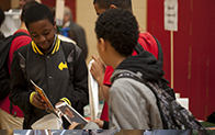 younger students looking at brochure