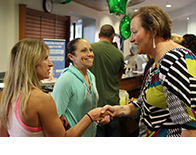 two students meet with the college president