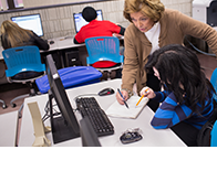 instructor helping student on computer