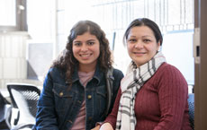 two students smiling in computer lab