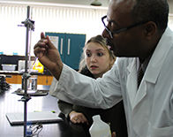 chemistry instructor helping student