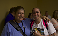 two students looking at camera and smiling