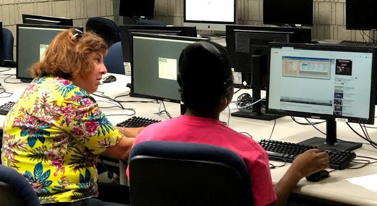 MAICEI student and teacher in computer lab