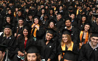 graduates sitting together and smiling